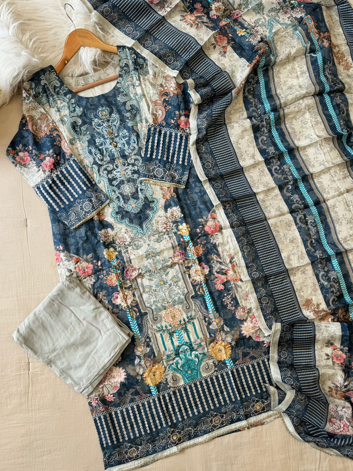 Muslin Stitched Suit featuring aari work detailings
