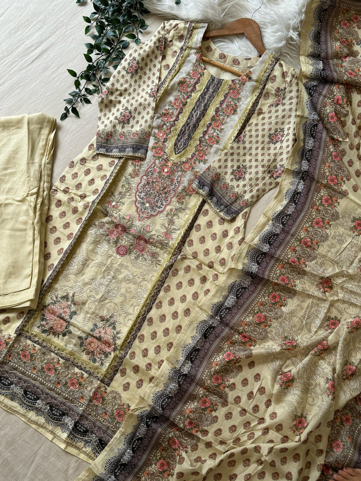 Muslin Stitched Suit featuring aari work details